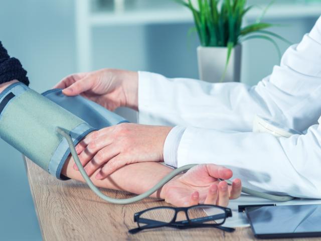 Médico midiendo la presión arterial de un paciente