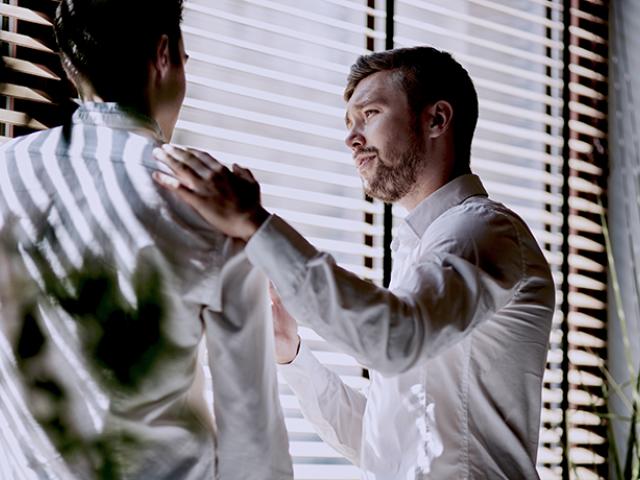 Man consoling a coworker at work