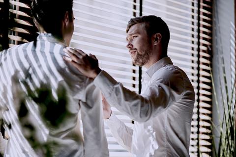 Man consoling a coworker at work